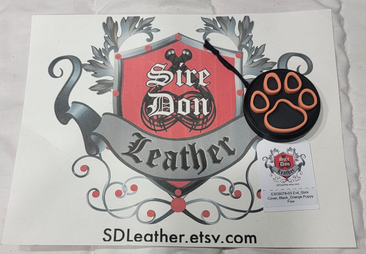 Evil_Stick Cover, Black_Orange Puppy Paw---Mature Content — photograph 1