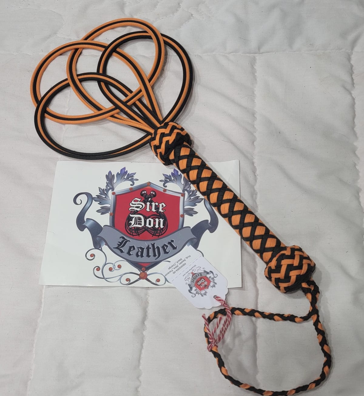 Rug_Beater_Wire_Paracord Black_Orange — photograph 1