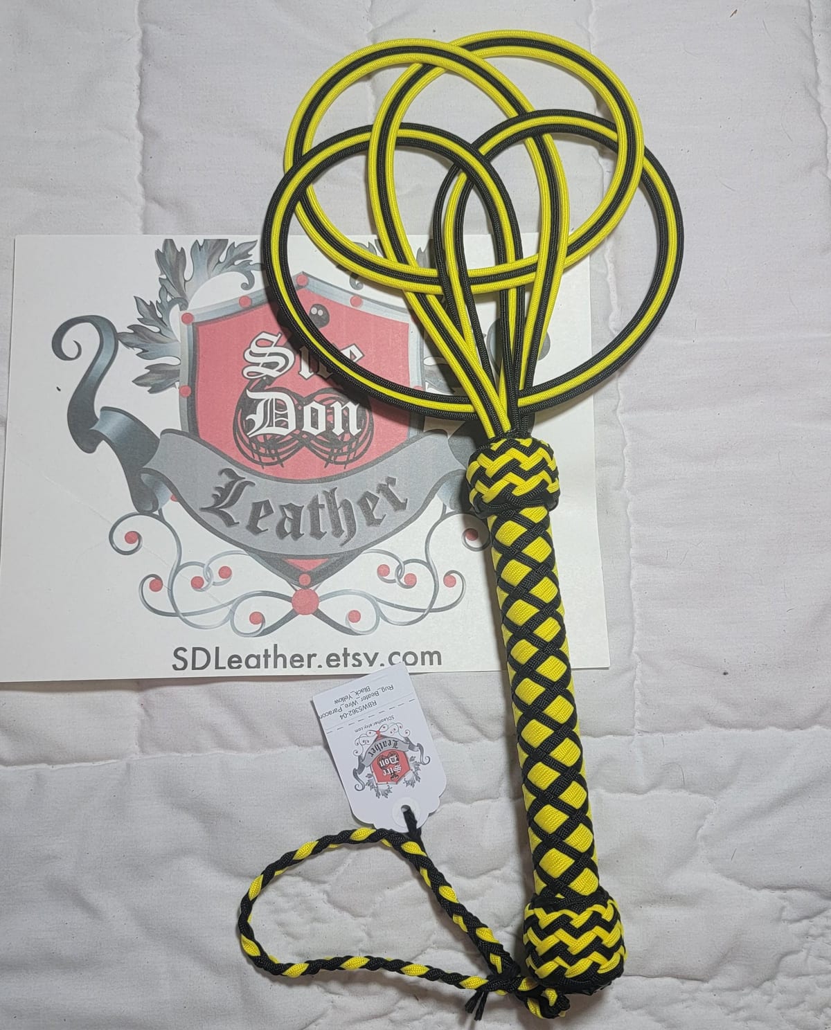 Rug_Beater_Wire_Paracord Black_Yellow — photograph 1